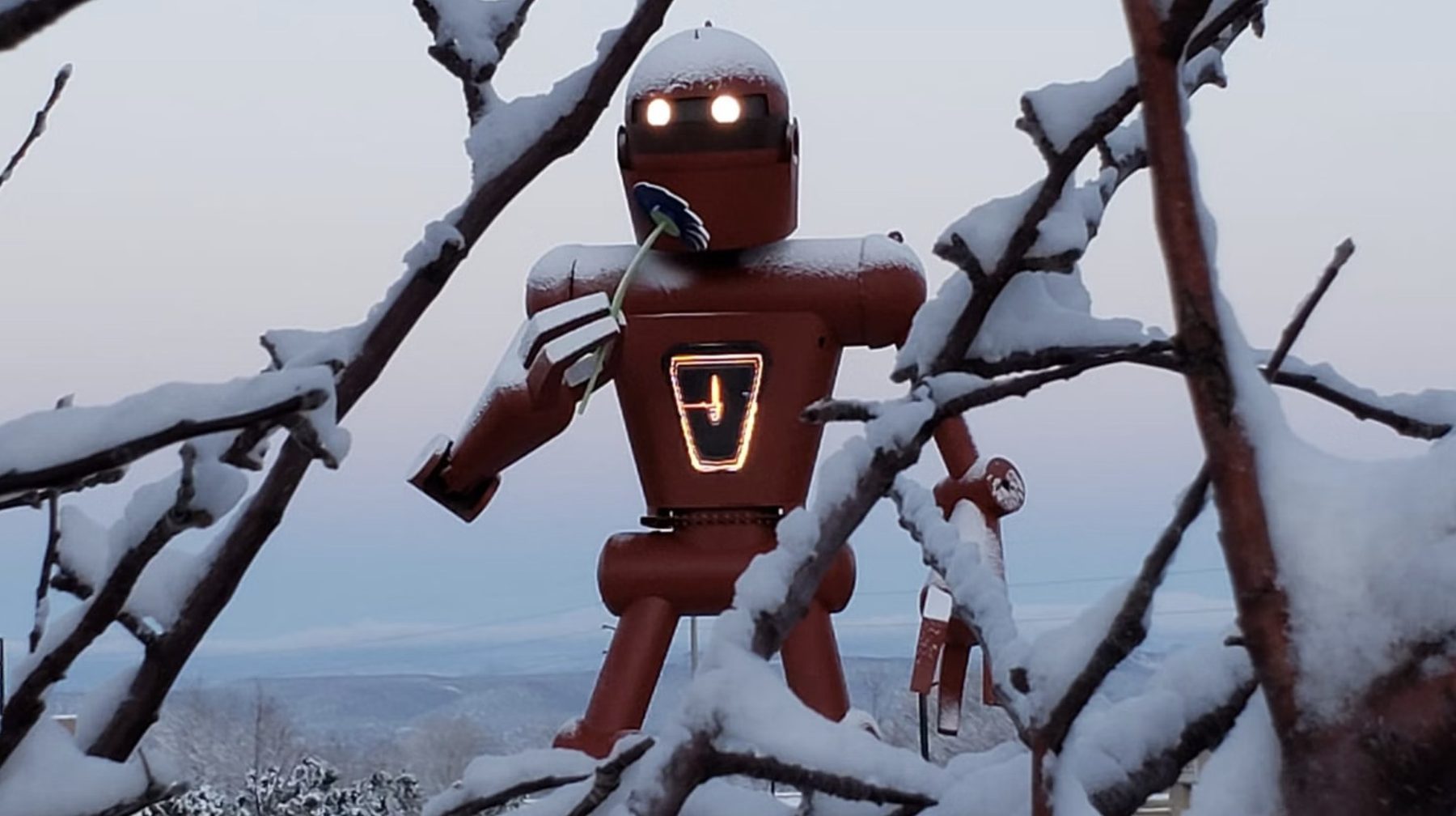 The Meow Wolf robot glowing in the snow