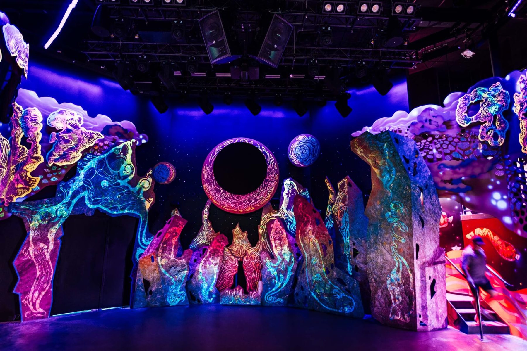 Theta Theater stage glowing under blacklight